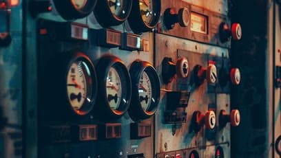 A wall of vintage control panel dials and switches